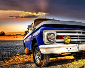 A Blue Truck Parked In The Dirt Wallpaper