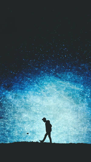 A Boy Taking In The Celestial Beauty Of The Night Sky Wallpaper