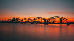 A Breathtaking Sunset At Riga's Railway Beach Wallpaper