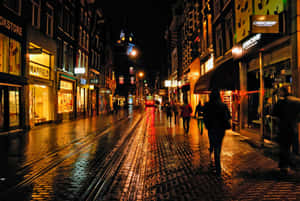 A Brick Street With People Walking Wallpaper