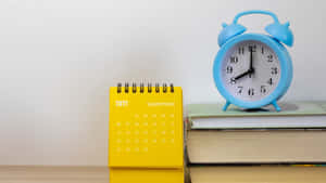 A Calendar And Books On A Table Wallpaper