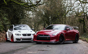 A Captivating Showdown Between The Nissan Skyline Gtr R35 And A Stunning White Bmw. Wallpaper