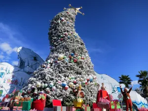 A Christmas Tree With A Large Number Of Presents On It Wallpaper