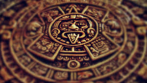 A Circular Aztec Calendar With A Sun And Moon Wallpaper