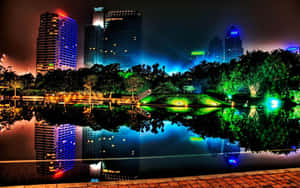 A City At Night With Lights Reflecting In The Water Wallpaper