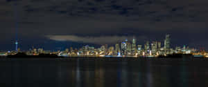 A City Skyline At Night Wallpaper