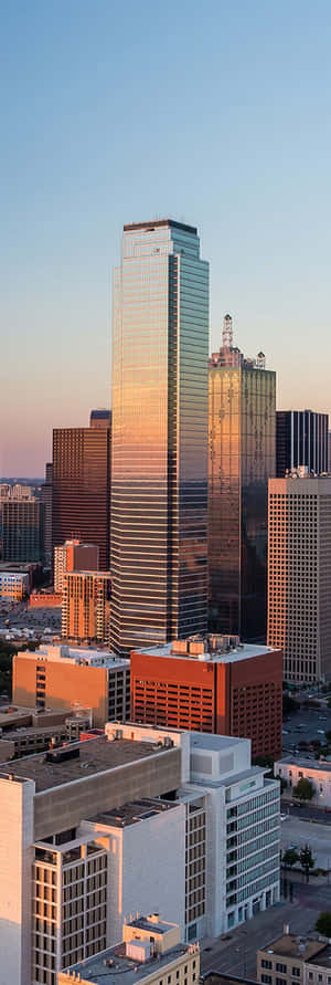 A City Skyline With Buildings And Trees Wallpaper