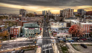 A City Street With Cars And Buildings Wallpaper