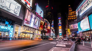 A City Street With Many Billboards And Signs Wallpaper