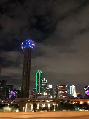 A City With A Blue And Green Light Tower Wallpaper