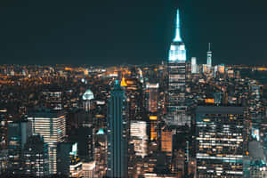 A Cityscape At Night With Lights On Wallpaper