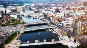 A Cityscape With A River And Buildings Wallpaper