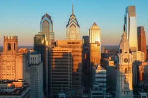 A Cityscape With Tall Buildings And A Clock Tower Wallpaper