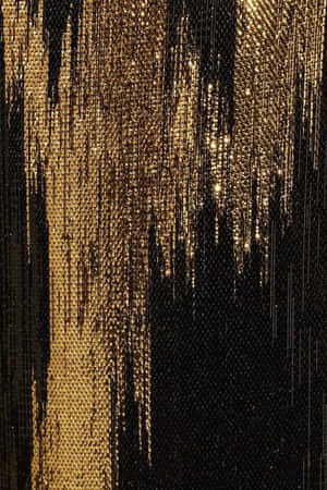 A Close Up Of A Black And Gold Sequin Dress Wallpaper