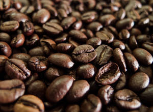 A Close-up View Of High-quality, Dark Roasted Coffee Beans Wallpaper