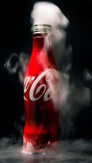 A Coca Cola Bottle With Smoke Coming Out Of It Wallpaper