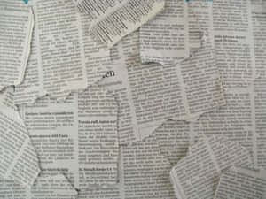 A Collage Of Newspaper Pieces With A Blue Background Wallpaper