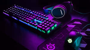 A Computer Keyboard And Mouse With Purple Lights Wallpaper