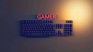 A Computer Keyboard With The Word Gamer On It Wallpaper