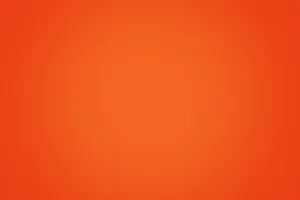 A Contrast Between Mundane And Vibrancy With Plain Orange Wallpaper