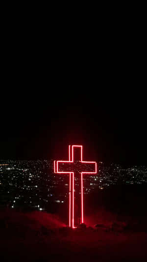 A Cross Of Worship Lit Up Aesthetically Wallpaper