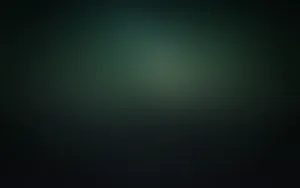 A Dark Green Background With A Blurred Background Wallpaper