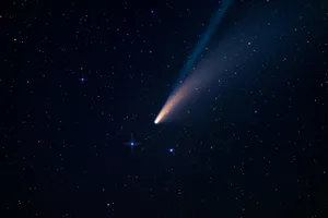 A Dazzling Comet Streaks Across The Night Sky Wallpaper