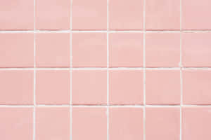 A Delicate, Pastel Pink Laptop Sits Atop A Marble Desktop. Wallpaper