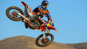 A Dirt Bike Rider In Mid Air Wallpaper