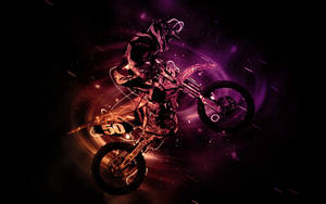 A Dirt Bike Rider Is Flying Through The Air Wallpaper