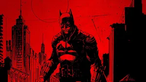 A Fearsome Batman Surveys The City Of Gotham Wallpaper