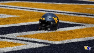A Football Helmet Is Sitting On The Field Wallpaper