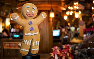 A Gingerbread Man Is Sitting On A Table Wallpaper