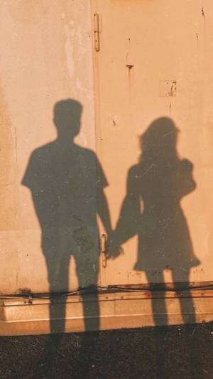 A Girl And Boy Shadow On The Wall Wallpaper