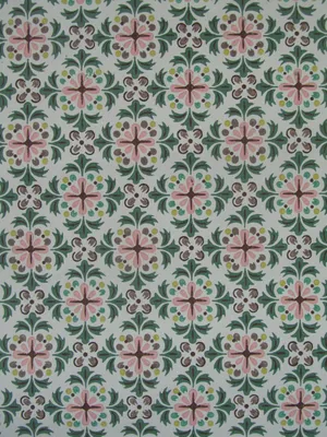 A Green And Pink Tile With Floral Designs Wallpaper