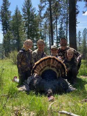 A Group Of People Posing With A Turkey Wallpaper