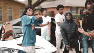 A Group Of People Standing Around A White Car Wallpaper