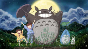 A Group Of People Standing In The Grass With Totoro Wallpaper