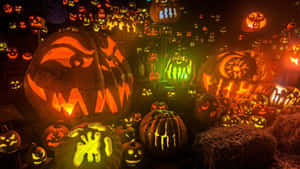 A Group Of Pumpkins With Glowing Faces Wallpaper