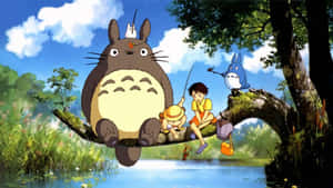 A Group Of Totoro Characters Sitting On A Tree Branch Wallpaper