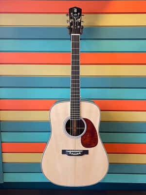 A Guitar Is Sitting Against A Colorful Wall Wallpaper