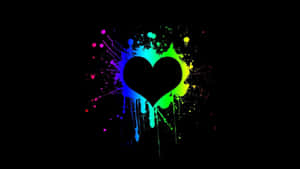 A Heart With Paint Splatters On A Black Background Wallpaper
