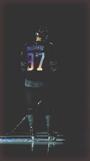 A Hockey Player Is Standing On The Ice Wallpaper