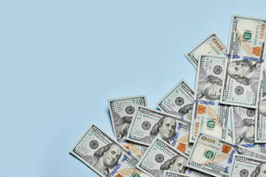 A Hundred-dollar Bill With Vibrant Blue Hues Wallpaper