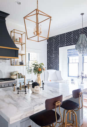 A Kitchen With A Marble Counter Top And Gold Stools Wallpaper