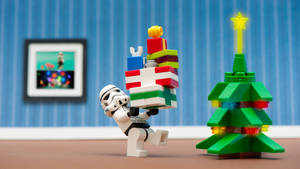 A Lego Stormtrooper Carrying A Christmas Tree Wallpaper
