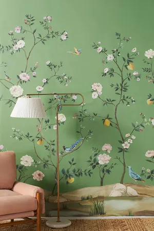 A Living Room With A Green Wall And A Chair Wallpaper