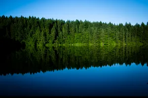 A Majestic View Of A Waterfall Cascading Down A Mountainside Wallpaper