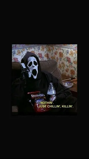A Man In A Mask Is Sitting On A Couch Wallpaper