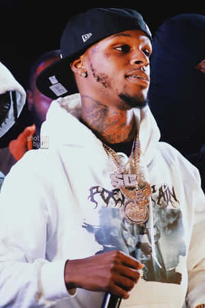 A Man In A White Hoodie Is Holding A Microphone Wallpaper